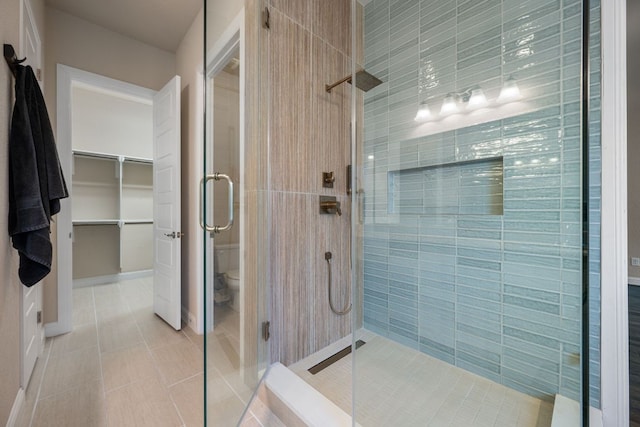 19817 Chayton Cir, Pflugerville, TX 78660 - full bath featuring a stall shower, toilet, tile patterned flooring, and a spacious closet