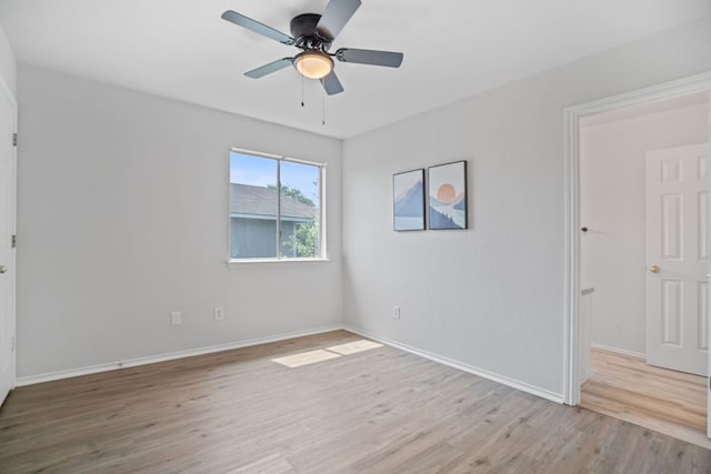 unfurnished room featuring wood finished floors, baseboards, and ceiling fan