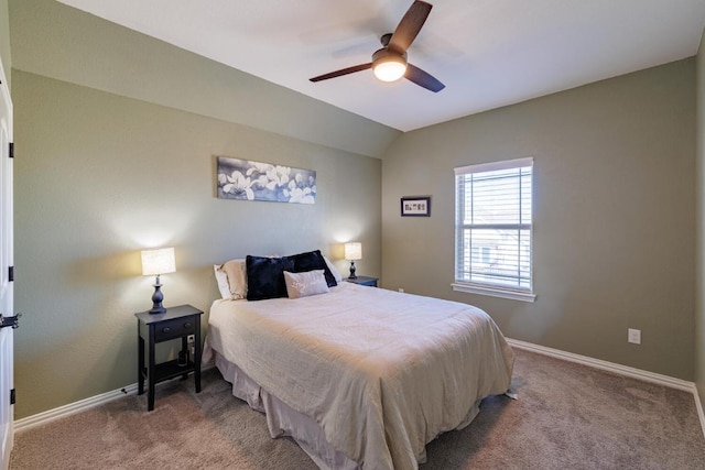 bedroom featuring carpet, baseboards, vaulted ceiling, and a ceiling fan