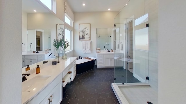 1026 Painted Horse Dr, Georgetown, TX 78633 - bathroom with a shower stall, two vanities, a soaking tub, tile patterned flooring, and recessed lighting