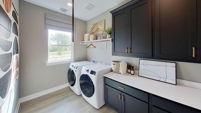 1026 Painted Horse Dr, Georgetown, TX 78633 - washroom with cabinet space, washing machine and dryer, light wood finished floors, and baseboards