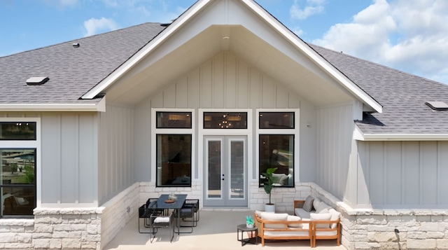 1026 Painted Horse Dr, Georgetown, TX 78633 - property entrance with french doors, roof with shingles, a patio, and board and batten siding