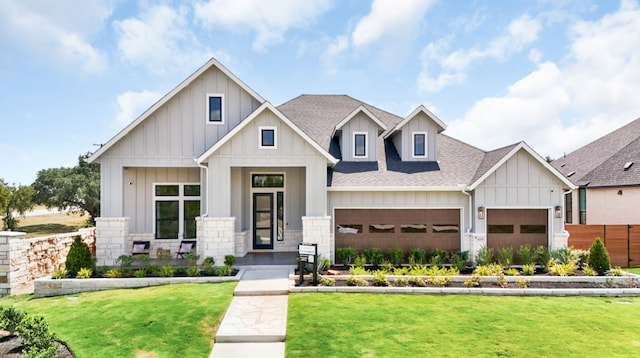 1026 Painted Horse Dr, Georgetown, TX 78633 - view of front of house featuring a shingled roof, board and batten siding, a garage, a front yard, and stone siding