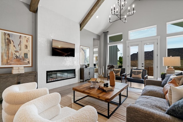 1026 Painted Horse Dr, Georgetown, TX 78633 - living room with high vaulted ceiling, beam ceiling, light wood-style floors, a fireplace, and a chandelier