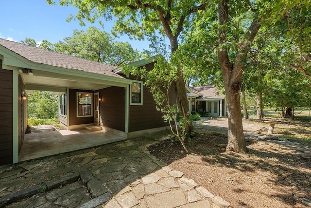 16704 Post Oak Gln, Austin, TX 78737 - view of side of property featuring a shingled roof