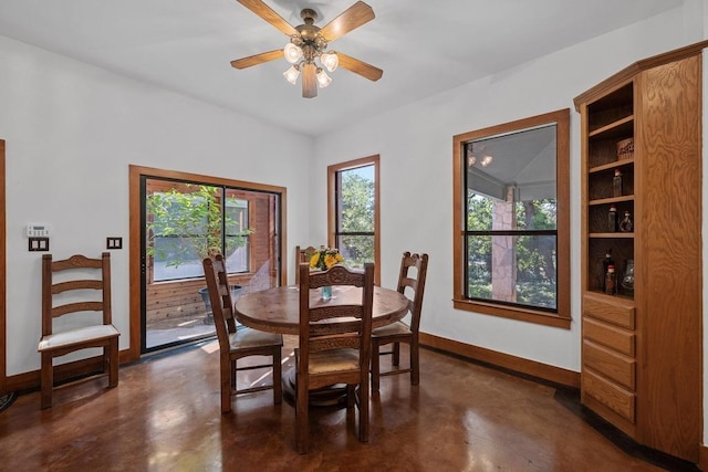 16704 Post Oak Gln, Austin, TX 78737 - dining room featuring concrete floors, baseboards, and a ceiling fan