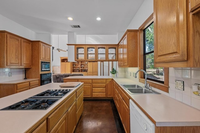 16704 Post Oak Gln, Austin, TX 78737 - kitchen featuring a sink, black appliances, light countertops, decorative backsplash, and recessed lighting
