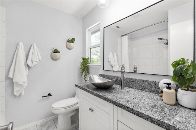 bathroom with baseboards, toilet, a shower with shower curtain, vanity, and marble look tiles