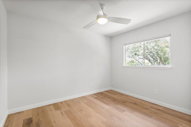 unfurnished room with baseboards, light wood finished floors, and a ceiling fan