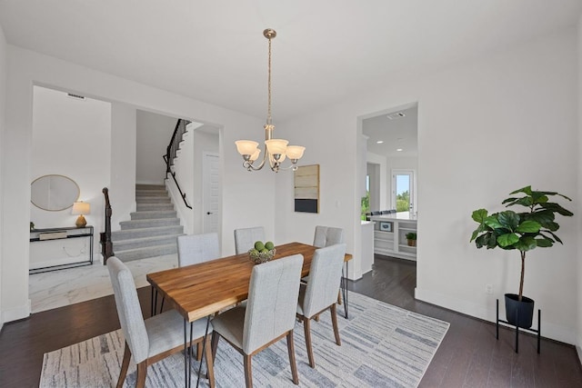 dining room featuring stairway, a chandelier, wood finished floors, baseboards, and recessed lighting