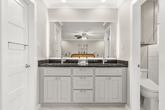 full bathroom with crown molding, ceiling fan, ensuite bath, double vanity, and toilet