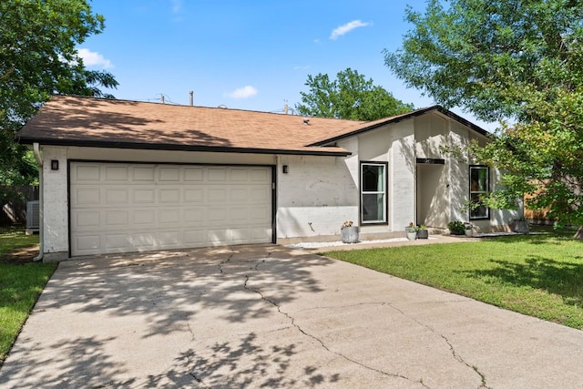 mid-century inspired home with concrete driveway, an attached garage, and a front yard
