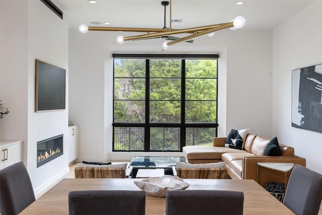 903 Alexia Ln, Austin, TX 78746 - living area with a chandelier, a glass covered fireplace, and recessed lighting