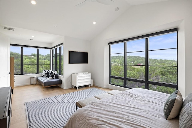 903 Alexia Ln, Austin, TX 78746 - bedroom with multiple windows, recessed lighting, light wood-style floors, vaulted ceiling, and baseboards