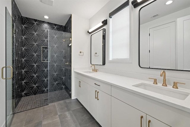 903 Alexia Ln, Austin, TX 78746 - bathroom featuring a shower stall, double vanity, and recessed lighting