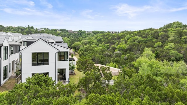 903 Alexia Ln, Austin, TX 78746 - exterior space with stucco siding, a wooded view, and a balcony