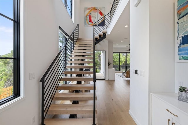903 Alexia Ln, Austin, TX 78746 - stairway featuring a towering ceiling and wood finished floors