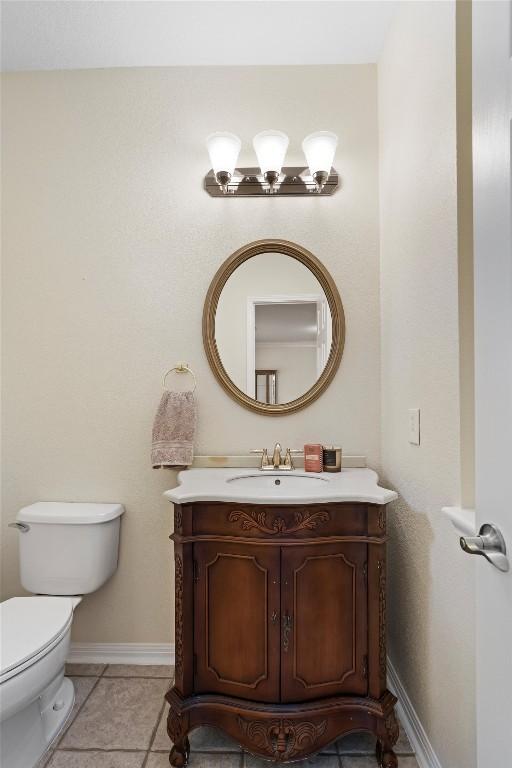 17112 Crescent Heights Trl, Austin, TX 78717 - half bathroom featuring vanity, toilet, baseboards, and tile patterned flooring