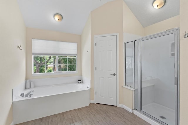 17112 Crescent Heights Trl, Austin, TX 78717 - full bath with a bath, wood finished floors, a stall shower, lofted ceiling, and baseboards