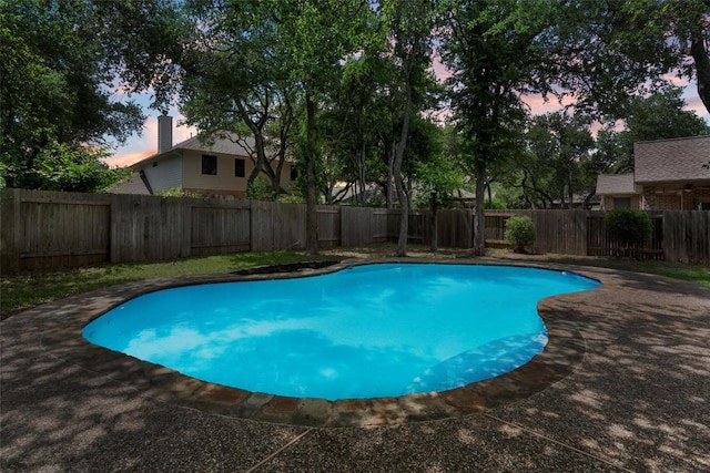 17112 Crescent Heights Trl, Austin, TX 78717 - pool at dusk with a fenced backyard