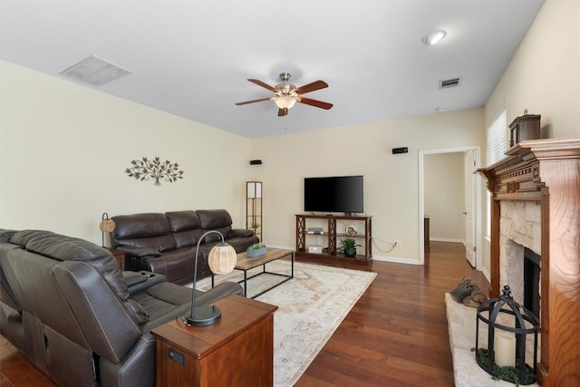 17112 Crescent Heights Trl, Austin, TX 78717 - living room featuring a ceiling fan, a fireplace, dark wood-style floors, and baseboards