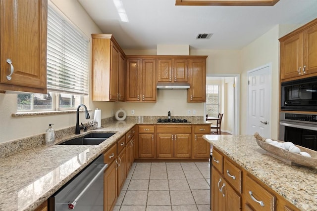 17112 Crescent Heights Trl, Austin, TX 78717 - kitchen featuring black appliances, a sink, under cabinet range hood, brown cabinets, and healthy amount of natural light