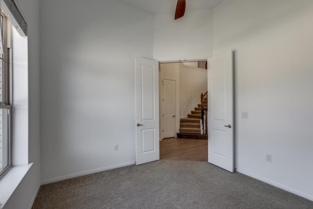 1314 Overture Pl, Round Rock, TX 78681 - unfurnished bedroom with carpet floors, baseboards, and a high ceiling