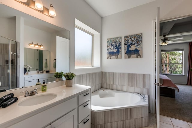 1314 Overture Pl, Round Rock, TX 78681 - ensuite bathroom with vanity, tile patterned floors, a bath, a stall shower, and ceiling fan