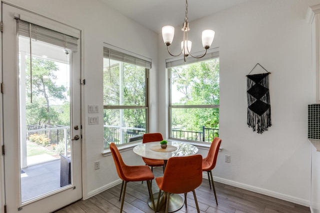 1314 Overture Pl, Round Rock, TX 78681 - dining room with a chandelier, wood finished floors, and healthy amount of natural light