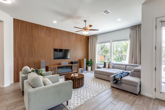 1314 Overture Pl, Round Rock, TX 78681 - living room featuring an accent wall, light wood-style floors, a ceiling fan, recessed lighting, and baseboards