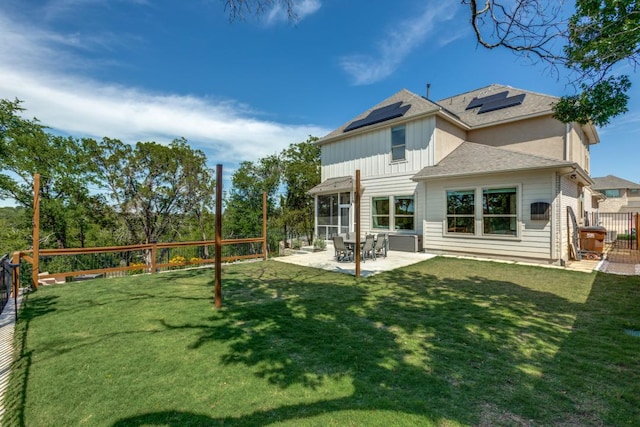 1314 Overture Pl, Round Rock, TX 78681 - rear view of house featuring board and batten siding, solar panels, a patio, and a shingled roof