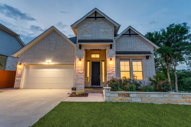 1314 Overture Pl, Round Rock, TX 78681 - view of front facade with an attached garage, brick siding, concrete driveway, a front yard, and stone siding
