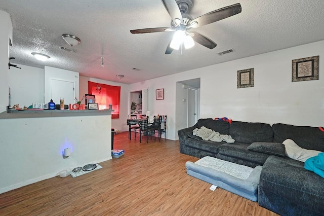 5405 Rose Hill Cir, Austin, TX 78745 - living room featuring wood finished floors, a textured ceiling, and ceiling fan