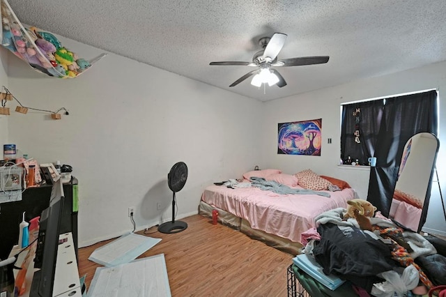 5405 Rose Hill Cir, Austin, TX 78745 - bedroom with wood finished floors, a textured ceiling, and ceiling fan