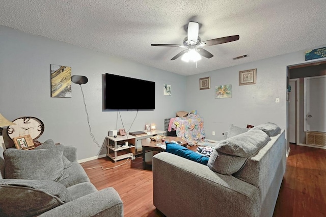 5405 Rose Hill Cir, Austin, TX 78745 - living room featuring wood finished floors, ceiling fan, and a textured ceiling