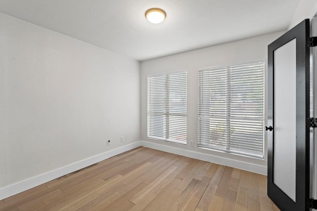 909 Reinli St Unit 101, Austin, TX 78751 - unfurnished room featuring baseboards and light wood-style flooring