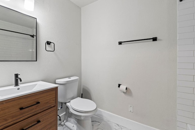 909 Reinli St Unit 101, Austin, TX 78751 - bathroom with vanity, marble finish flooring, toilet, a shower, and baseboards