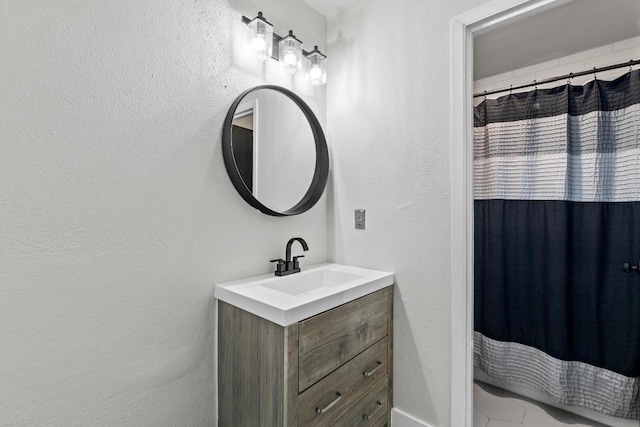 909 Reinli St Unit 101, Austin, TX 78751 - full bathroom featuring vanity, a textured wall, and a shower with shower curtain