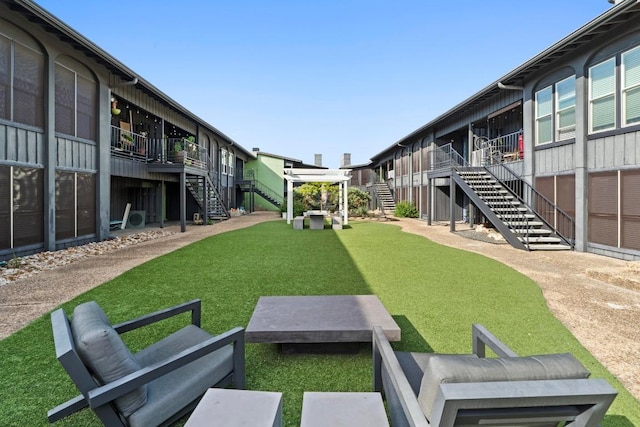 909 Reinli St Unit 101, Austin, TX 78751 - view of property's community with stairway, a yard, and a deck