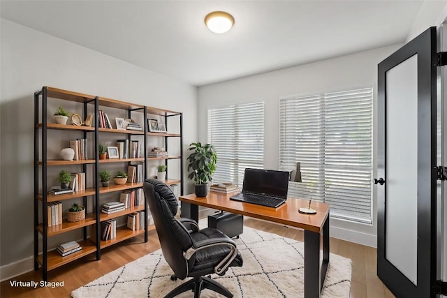 909 Reinli St Unit 101, Austin, TX 78751 - office area featuring wood finished floors and baseboards