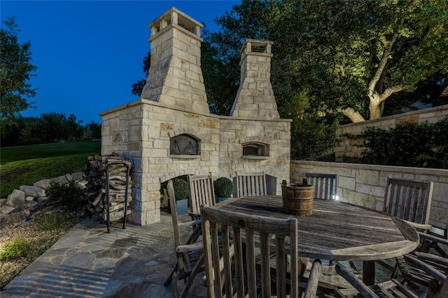 view of patio / terrace with an outdoor stone fireplace and outdoor dining area