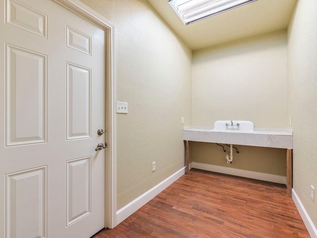 119 E Wiamea Ct, Bastrop, TX 78602 - washroom featuring wood finished floors and a textured wall
