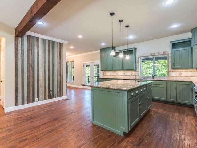 119 E Wiamea Ct, Bastrop, TX 78602 - kitchen with green cabinetry, ornamental molding, dark wood-style floors, plenty of natural light, and recessed lighting