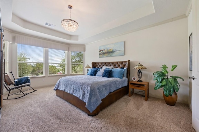 100 Royal Oak Dr, Georgetown, TX 78628 - carpeted bedroom with a raised ceiling, a chandelier, and baseboards