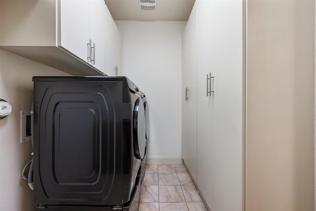 100 Royal Oak Dr, Georgetown, TX 78628 - laundry area featuring cabinet space, washing machine and clothes dryer, baseboards, and light marble finish floors