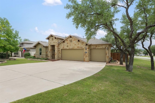 100 Royal Oak Dr, Georgetown, TX 78628 - view of front of home with stone siding, an attached garage, driveway, and a front yard