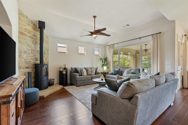 100 Royal Oak Dr, Georgetown, TX 78628 - living room with a wood stove, ceiling fan, dark wood-type flooring, and lofted ceiling