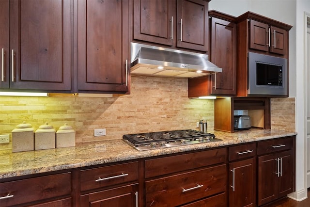 100 Royal Oak Dr, Georgetown, TX 78628 - kitchen with under cabinet range hood, appliances with stainless steel finishes, and decorative backsplash