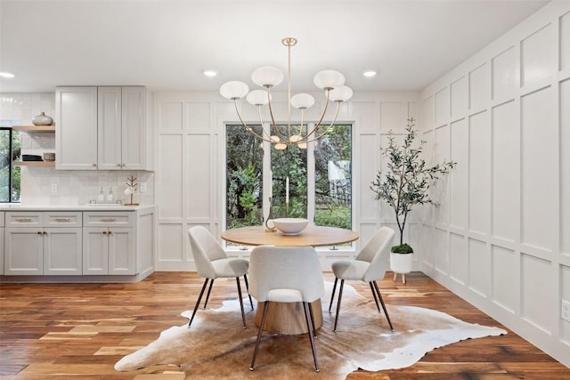 210 Hazeltine Dr, Lakeway, TX 78734 - dining area featuring a decorative wall, a chandelier, plenty of natural light, light wood-style floors, and recessed lighting
