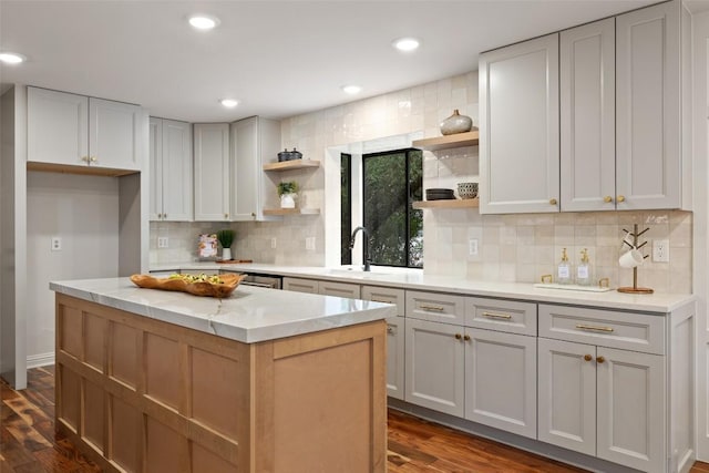 210 Hazeltine Dr, Lakeway, TX 78734 - kitchen with open shelves, a sink, decorative backsplash, dark wood-type flooring, and recessed lighting